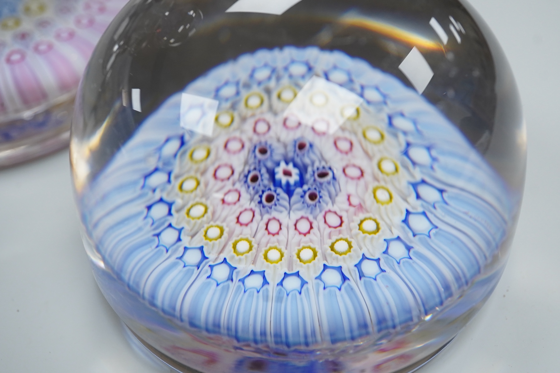 Two millefiori glass paperweights and an inkwell, 12cm high